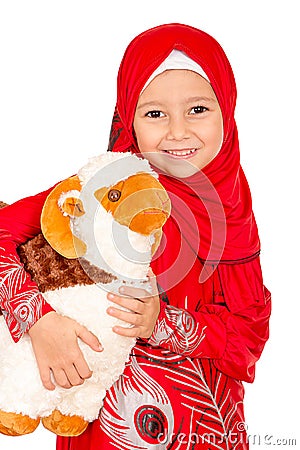 Happy little girl playing with her sheep toy - celebrating Eid u Stock Photo