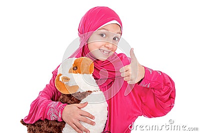 Happy little girl playing with her sheep toy - celebrating Eid u Stock Photo