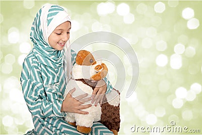 Happy little girl playing with her sheep toy - celebrating Eid u Stock Photo