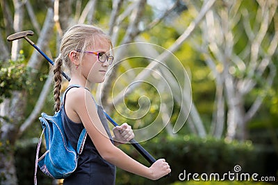 Happy little girl playing mini golf. Stock Photo