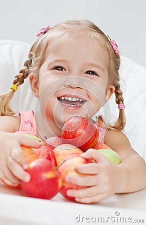 Happy little girl with red apple Stock Photo