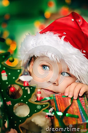 Happy little girl in Santa's hat has a Christmas Stock Photo