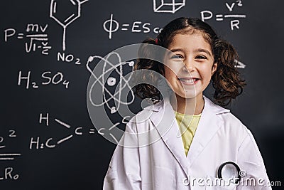 Happy little girl science student in lab coat Stock Photo