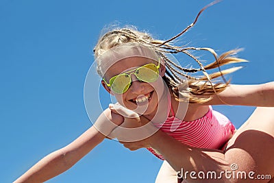 Happy little girl in a Sunny yellow glasses Stock Photo