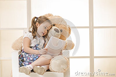 Happy little girl with Teddy bear Stock Photo