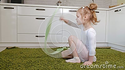 A Happy Little Girl in a White Gymnastic Swimsuit Trains, Dances with a Ribbon for Rhythmic Gymnastics, Jumps and Stock Video - Video of girl, aerobics: 139417687 