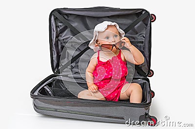 Happy little kid inside suitcase isolated on white Stock Photo