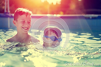 Happy little kid learn swimming with brother vintage style Stock Photo