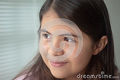 Happy little latin girl looking with hope. Portrait Stock Photo