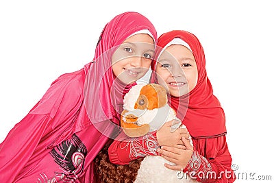 Happy little Muslim girls playing with sheep toy - celebrating E Stock Photo