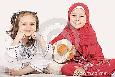 Happy little Muslim girls playing with sheep toy - celebrating E Stock Photo