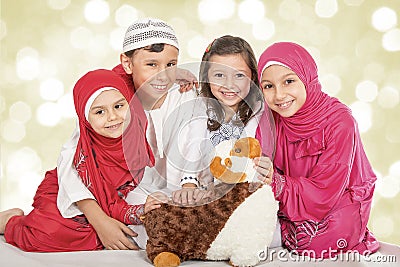 Happy little Muslim kids playing with sheep toy - celebrating Eid ul Adha - Happy Sacrifice Feast Stock Photo