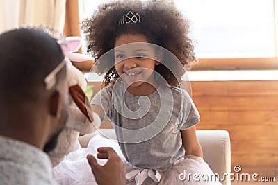 Happy little preschool cute girl playing with daddy. Stock Photo