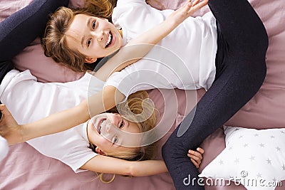 Siblings playing in bed Stock Photo