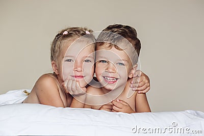 Happy little sister hugging her brother Stock Photo