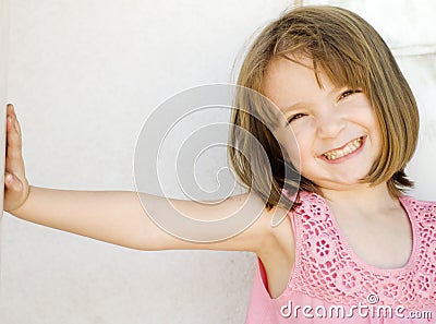 Happy little smiling girl leaning Stock Photo