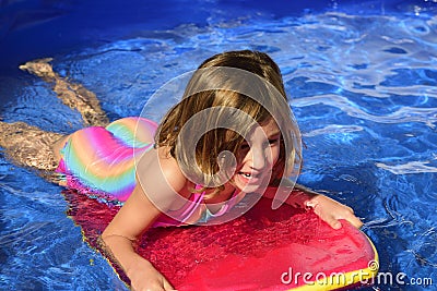 Happy little surfer girl with surf board Stock Photo