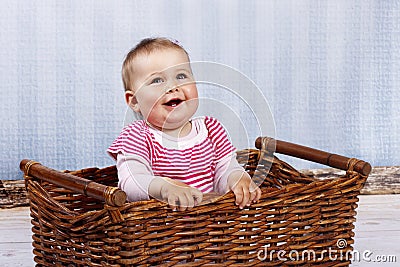 Happy little toddler laughing in the basket Stock Photo