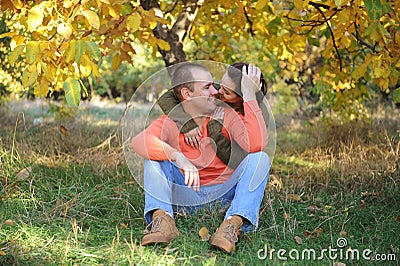 Happy love couple resting in forest and embracing, young family portrait, casual wear Stock Photo