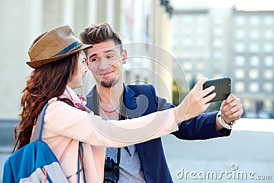 Happy love couple of tourists taking selfie in urban city Stock Photo