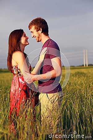 Happy lovers in field Stock Photo