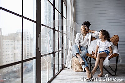 Happy loving afro american family. Young mother and her daughter playing in the nursery Stock Photo