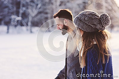 Happy loving couple walking in snowy winter forest, spending christmas vacation together. Outdoor seasonal activities Stock Photo