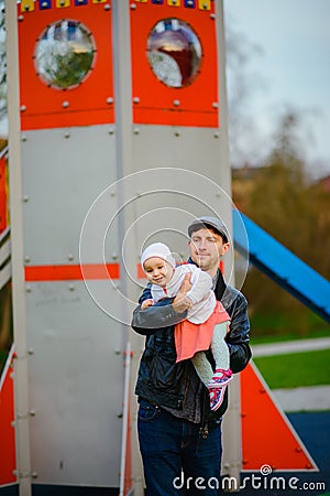 Happy loving family. Father and his daughter child girl playing and hugging outdoors. Cute little girl hugs daddy. Concept of Stock Photo