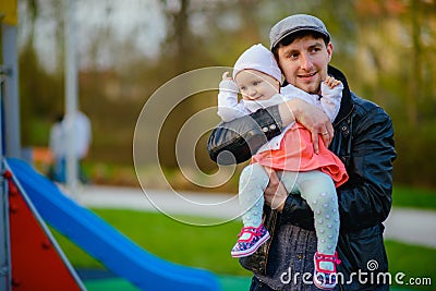 Happy loving family. Father and his daughter child girl playing and hugging outdoors. Cute little girl hugs daddy. Concept of Stock Photo