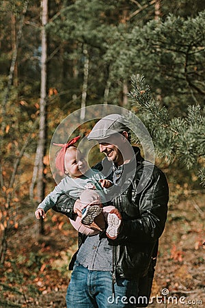 Happy loving family. Father and his daughter child girl playing and hugging outdoors. Cute little girl hugs daddy. Concept of Stock Photo