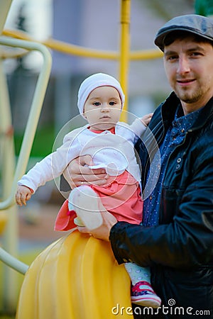 Happy loving family. Father and his daughter child girl playing and hugging outdoors. Cute little girl hugs daddy. Concept of Stock Photo