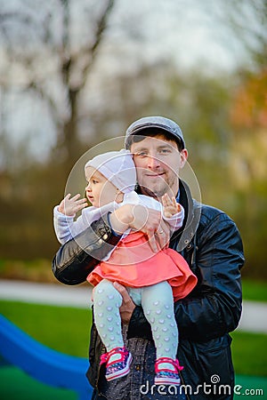 Happy loving family. Father and his daughter child girl playing and hugging outdoors. Cute little girl hugs daddy. Concept of Stock Photo