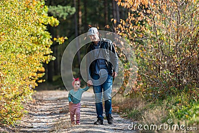 Happy loving family. Father and his daughter child girl playing and hugging outdoors. Cute little girl hugs daddy. Concept of Stock Photo