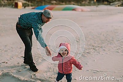 Happy loving family. Father and his daughter child girl playing and hugging outdoors. Cute little girl hugs daddy. Concept of Stock Photo