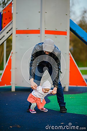 Happy loving family. Father and his daughter child girl playing and hugging outdoors. Cute little girl hugs daddy. Concept of Stock Photo