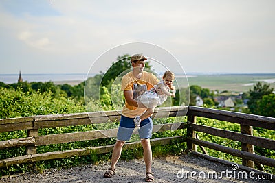 Happy loving family. Father and his daughter child girl playing and hugging outdoors. Cute little girl hugs daddy. Concept of Stock Photo