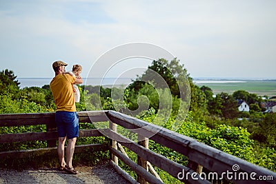 Happy loving family. Father and his daughter child girl playing and hugging outdoors. Cute little girl hugs daddy. Concept of Stock Photo