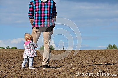 Happy loving family. Father and his daughter child girl playing and hugging outdoors in the field. Cute little girl hugs daddy. Stock Photo