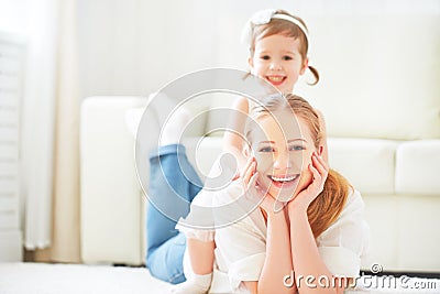 Happy loving family. mother and child playing lying on the floor Stock Photo