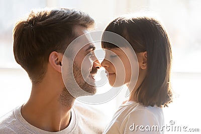 Happy loving father and kid daughter touching noses enjoy tenderness Stock Photo