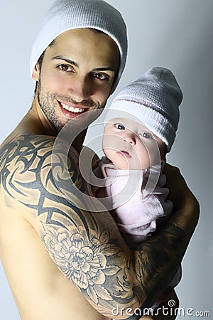 Happy handsome father holds his small newborn daughter Stock Photo