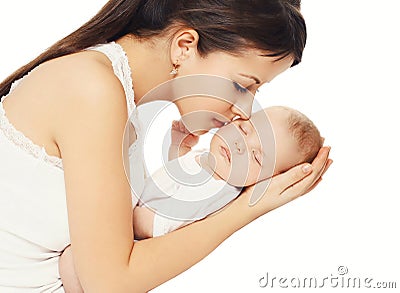 Happy loving mother kissing her baby holding on hands over white Stock Photo