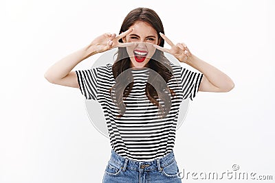 Happy lucky, optimstic attractive woman enjoy cool party, having fun dancing shouting emotive, show peace, victory signs Stock Photo