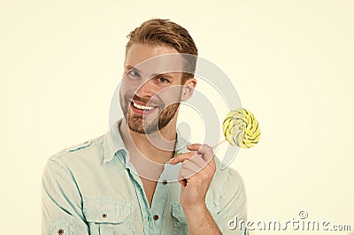 Happy macho with lollipop. Man smile with candy on stick isolated on white background. Food and snack. Unhealthy diet Stock Photo