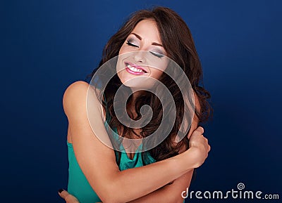 Happy makeup woman hugging herself with natural emotional enjoying face. Love concept of yourself body Stock Photo