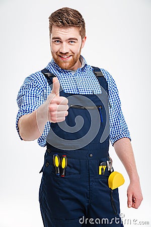 Happy male builder showing thumb up Stock Photo