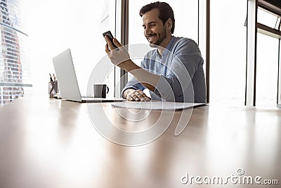 Happy male business leader, businessman with smartphone making video call Stock Photo