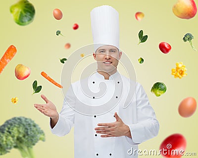 Happy male chef cook inviting Stock Photo