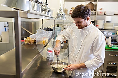 Happy male chef cooking food at restaurant kitchen Stock Photo