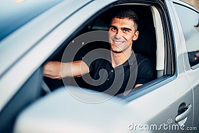 Happy male driver in car, advertising concept Stock Photo